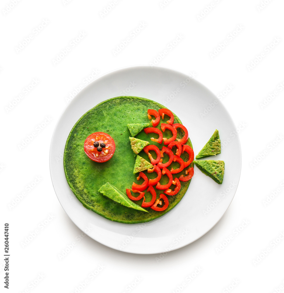 Plate with tasty green pancake for kid on white background