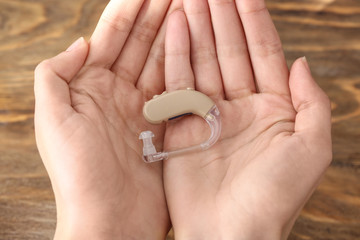 Female hands with hearing aid, closeup