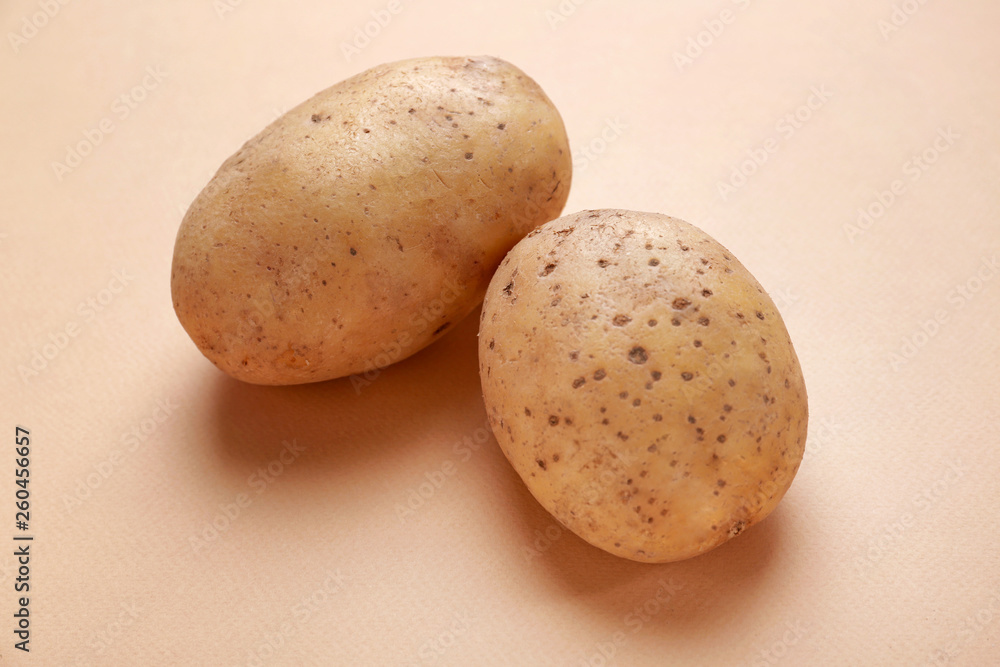 Raw potato on color background