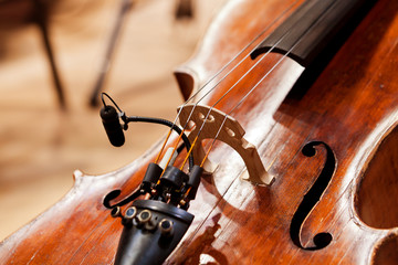 Sticker -  Fragment of a cello with a microphone in the orchestra close-up