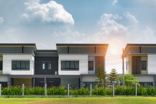 New House For Sale Or Rent On Blue Sky Background. Real Estate Concept,copy Space,A Row Of New Townhouses Or Condominiums.