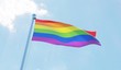 © Sasha Strekoza - LGBT flag waving against blue sky. 3d image