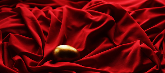 Sticker - Easter egg hand painted gold on a red background