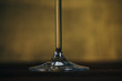 © Yuliia - glass leg of wine glass on a rustic wooden brown background. rest, holiday, party. crystal glass closeup. copy space