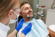© Drobot Dean - Happy young man sitting in medical dentist center.