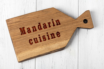 Wall Mural - Wooden cutting board with inscription. Concept of mandarin cuisine