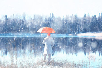 Wall Mural - winter walk with an umbrella / man in a coat with an umbrella, walk against the backdrop of the winter landscape, winter view