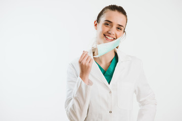 Wall Mural - Young nurse in a scrub uniform wearing a face mask.