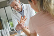 © goodluz - Physiotherapist working with patient's wrist injury