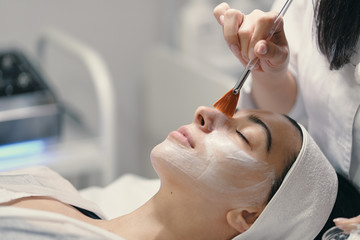 Close-up of the face of a young woman relaxing under the gentle