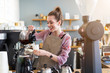 © pikselstock - Female barista making coffee