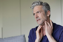 Mature Man With Sore Throat At Home