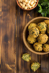 Wall Mural - Chickpea falafel in the brown bowl on the wooden  background.Top view.Copy space.