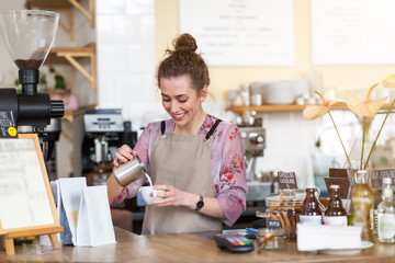 Wall Mural - Female barista making coffee 