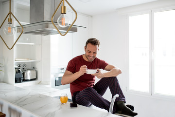 Wall Mural - Man having breakfast by the windows