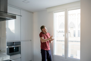 Wall Mural - Man having breakfast with mobile phone