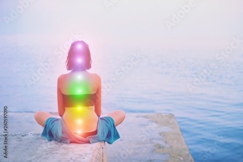 Portrait of young beautiful woman sits in a pose of half lotus practicing yoga m Canvas Print