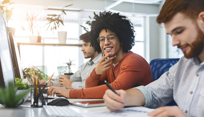 Work at IT company, friendly black guy smiling at camera
