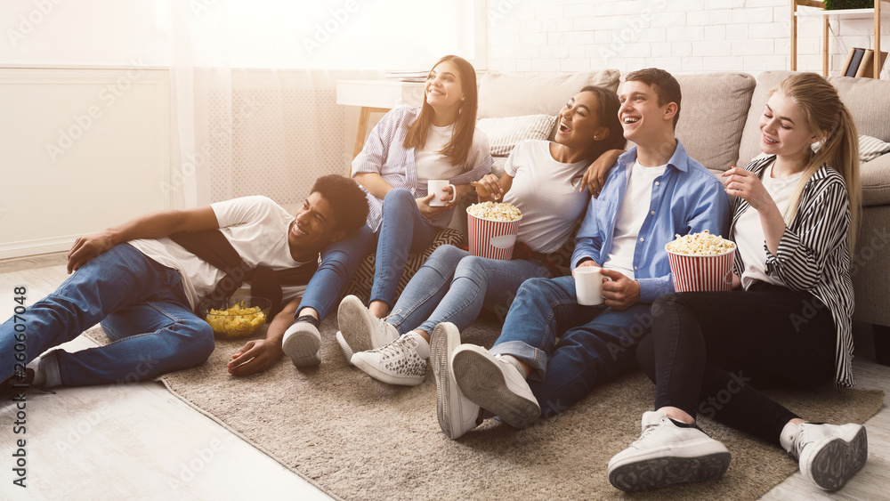 Happy friends watching comedy movie at home - obrazy, fototapety, plakaty 