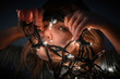 © Cavan Images - Close up of toddler girl peeking through christmas lights