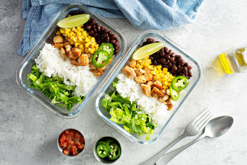 Healthy green mexican inspired meal prep with chicken, rice, beans, corn, salad