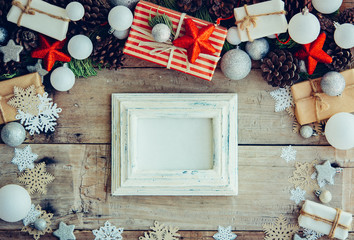 Wall Mural - Christmas background with gift boxes and decorations on the wood