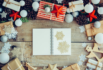 Wall Mural - Christmas background with letter and gift boxes on the wooden ta