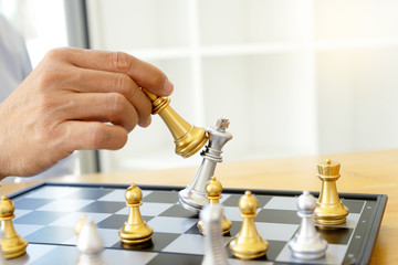 Businessman thinking and hold king chess