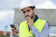 © auremar - builder talking on phone and smoking a cigarette