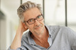 © goodluz - Portrait of handsome mature man wearing glasses smiling at camera