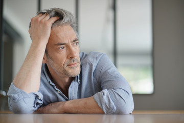 Wall Mural - Portrait of handsome mature man contemplating at home