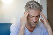 © goodluz - Mature man with bad headache at home