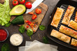 © Pixel-Shot - Grill pan with tasty fried spring rolls and ingredients on table