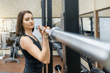 Wall Mural - Young beautiful athletic woman brunette doing fitness exercises in the gym. Fitness, sport, training, people, healthy lifestyle concept.