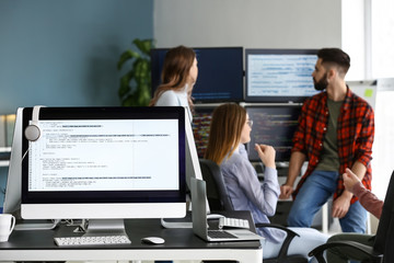 Wall Mural - Team of programmers working in office