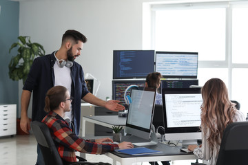 Wall Mural - team of programmers working in office