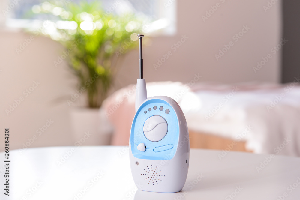 Modern baby monitor on table in room