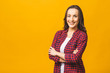 © denis_vermenko - Portrait of a pretty smiling woman in casual posing isolated on a yellow background.