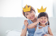 © paulaphoto - Portrait of asian mother and child daughter playing having fun together. Beautiful funny girl and mommy have crowns on sticks. Fun love family lifestyle single mom love mother’s day holiday concept
