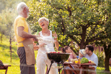 Senior couple make barbecue