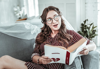 Wall Mural - Woman wearing wedding vail reading a book