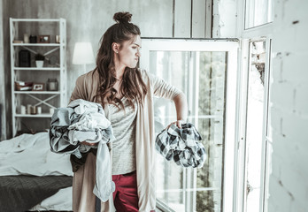 Wall Mural - Angry woman throwing the shirts of her ex away