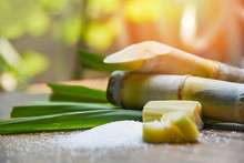 White Sugar And Sugar Cane On Wooden  Table And Nature Background