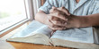 Close up hands of boy on holy bible and praying. christian concept.