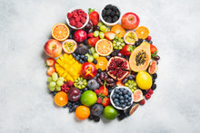 Circle Made Of Healthy Raw Rainbow Fruits, Mango Papaya Strawberries Oranges Passion Fruits Berries On Oval Serving Plate On Light Concrete Background, Top View, Copy Space, Selective Focus