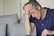 © goodluz - Mature man with bad headache at home
