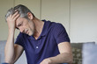 © goodluz - Mature man with bad headache at home
