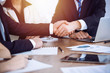 © rogerphoto - Business people shaking hands at meeting or negotiation in the office. Handshake concept. Partners are satisfied because signing contract