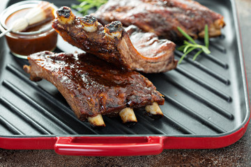 Sticker - Grilled bbq ribs with barbeque sauce on a grilling pan