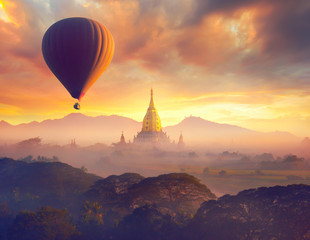 Canvas Print - Enjoying colorful sunset over of Buddhist stupas and hot air balloon in the ancient Bagan. Myanmar, Asia.